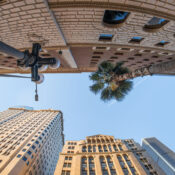 A fish-eye view looking up at tall classical buildings in Downtown Los Angeles Financial District