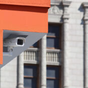 Security camera ucked into roof of parking structure with pre-war DTLA buildings in the background