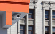 Security camera ucked into roof of parking structure with pre-war DTLA buildings in the background